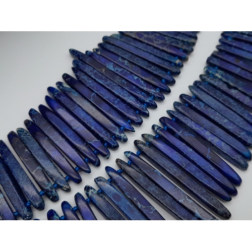 181 - A majestic, lapis lazuli, two strand necklace of pharaonic proportions, carrying needle-like long be... 