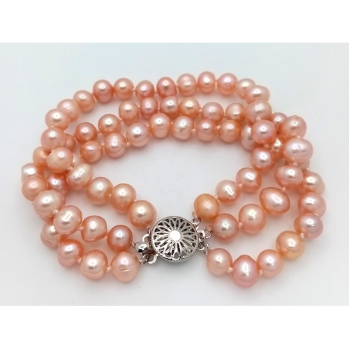 202 - A fashionable, vintage, three strand, high quality, natural pink pearls necklace, bracelet and earri... 