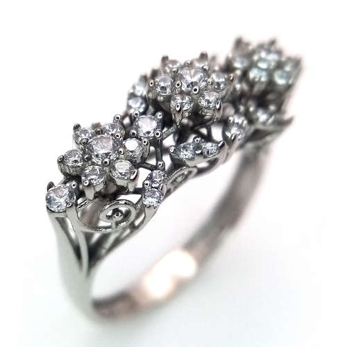 246 - A Vintage 18K White Gold Floral Form Ring. Three flowers with leaf surround. 1ctw diamonds. Size M 1... 