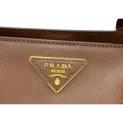 250 - A Prada Brown Saffiano Leather Double Tote Bag. Brown saffiano leather exterior with gold-toned hard... 