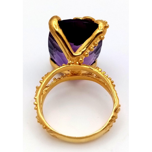 251 - A stunning sterling silver and 18K yellow gold-plated ornate ring with an impressive cushion cut ame... 