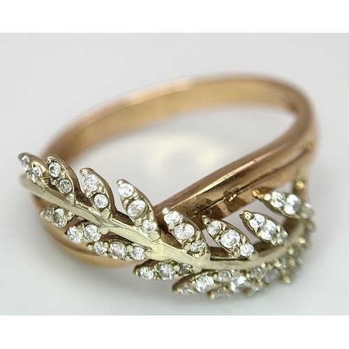 260 - An 18K Yellow Gold Diamond Leaf Form Crossover Ring. Size O 1/2. 3.2g