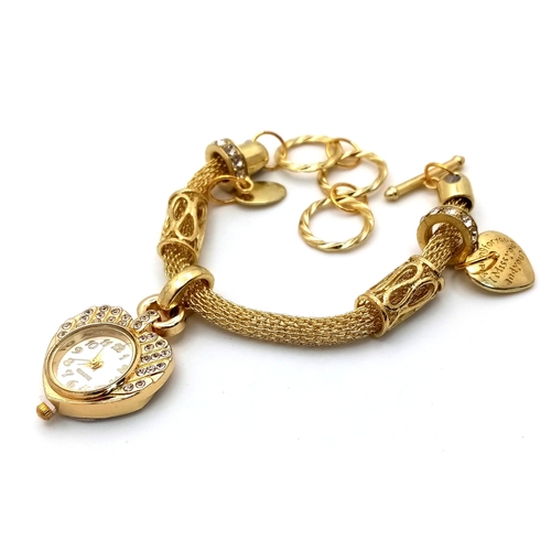 279 - A gold-plated fascinating bracelet watch with charms in a presentation box. Watch case 26 mm, quartz... 