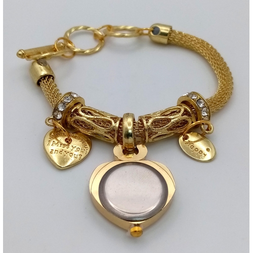 279 - A gold-plated fascinating bracelet watch with charms in a presentation box. Watch case 26 mm, quartz... 