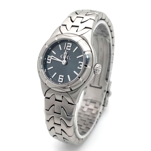 335 - An Ebel Type E Quartz Ladies Watch. Stainless steel bracelet and case - 26mm. Dark grey dial. In wor... 