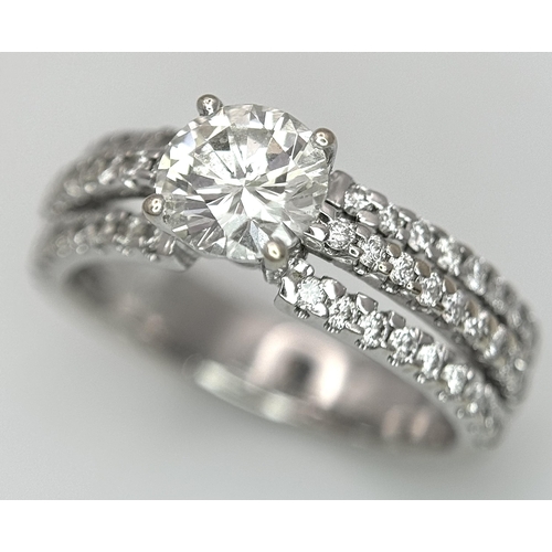 34 - A Stunning 18K white Gold and Diamond Ring. Brilliant round cut 0.70ctw centre diamond (SI1) with th... 