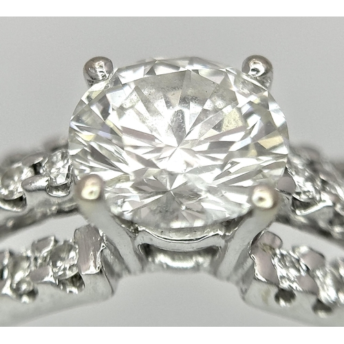 34 - A Stunning 18K white Gold and Diamond Ring. Brilliant round cut 0.70ctw centre diamond (SI1) with th... 