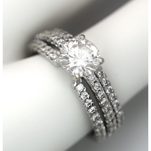 34 - A Stunning 18K white Gold and Diamond Ring. Brilliant round cut 0.70ctw centre diamond (SI1) with th... 