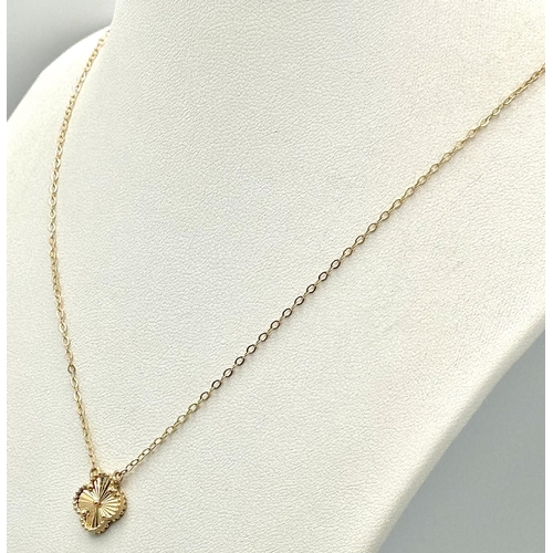 358 - An 18K Gold Attached Clover Pendant on an 18K Gold Disappearing Necklace. 12mm and 42cm. 2.7g