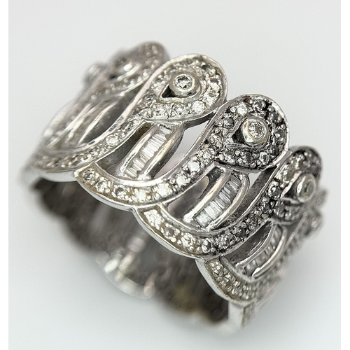 370 - An 18K White Gold and Diamond Crown Band Ring. Regal in nature with round and baguette cut diamonds ... 