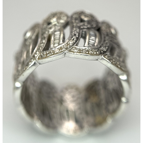 370 - An 18K White Gold and Diamond Crown Band Ring. Regal in nature with round and baguette cut diamonds ... 