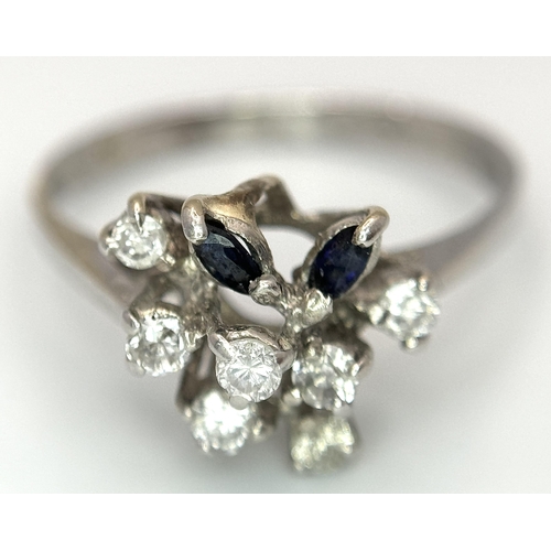 372 - A Vintage 18K White Gold, Diamond and Sapphire Floral Burst Ring. Size N. 2.6g