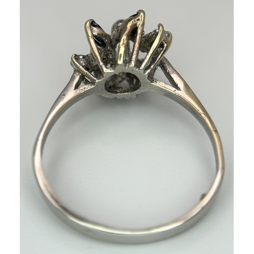 372 - A Vintage 18K White Gold, Diamond and Sapphire Floral Burst Ring. Size N. 2.6g