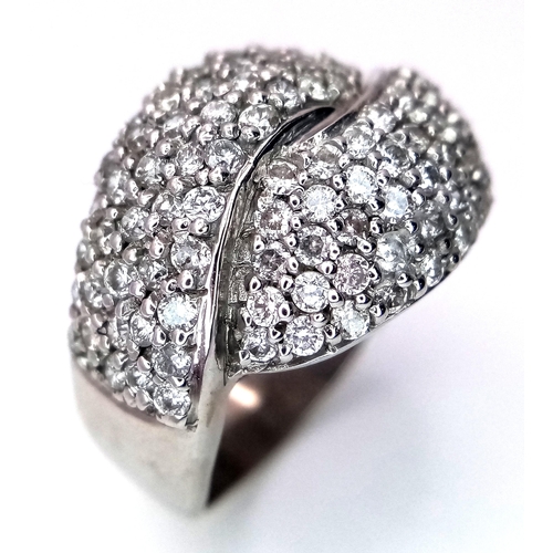 379 - An 18K White Gold Diamond Crossover Pave Ring. Size M. 7.25g total weight.