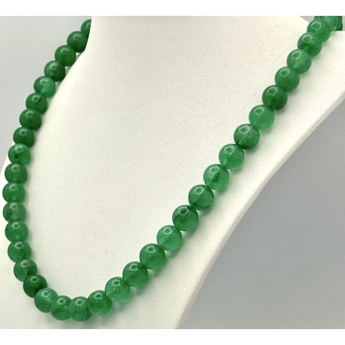 505 - A Jade Beaded Necklace with Silver Clasp. 48cm