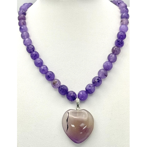 519 - An Amethyst Beaded Necklace with Heart Pendant. Silver clasp. 3cm and 52cm.