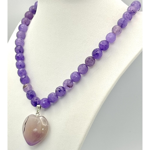 519 - An Amethyst Beaded Necklace with Heart Pendant. Silver clasp. 3cm and 52cm.