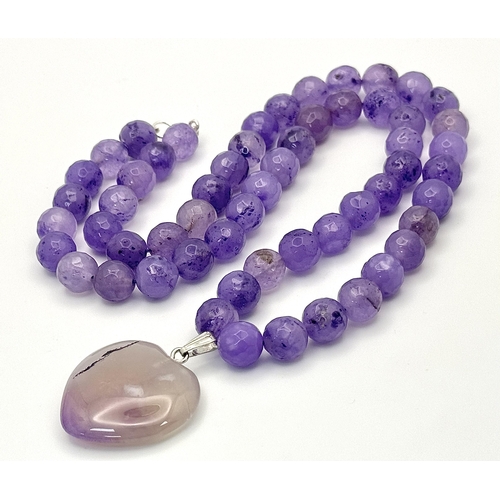 519 - An Amethyst Beaded Necklace with Heart Pendant. Silver clasp. 3cm and 52cm.