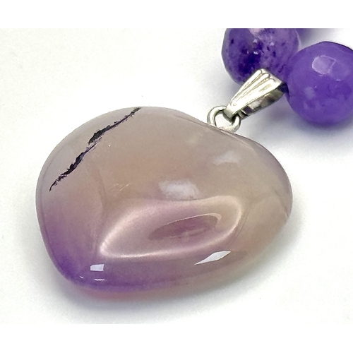 519 - An Amethyst Beaded Necklace with Heart Pendant. Silver clasp. 3cm and 52cm.