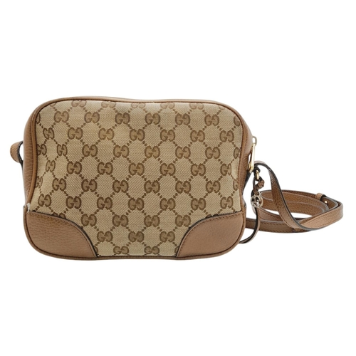 629 - A Gucci Monogram Bree Messenger Bag. Brown and beige monogram canvas exterior with brown leather tri... 