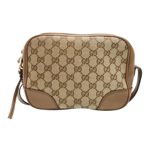 629 - A Gucci Monogram Bree Messenger Bag. Brown and beige monogram canvas exterior with brown leather tri... 