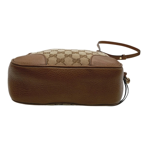 629 - A Gucci Monogram Bree Messenger Bag. Brown and beige monogram canvas exterior with brown leather tri... 