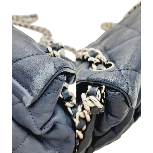 83 - A Chanel Washed Lambskin Quilted Messenger Bag. Blue leather exterior with silver-toned hardware, fe... 