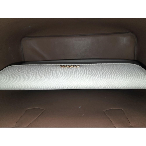 713 - A Prada Saffiano Leather Double Bag. White leather exterior with gold-tone hardware and top handles.... 