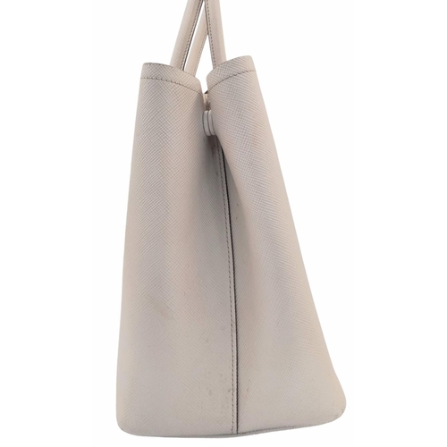 713 - A Prada Saffiano Leather Double Bag. White leather exterior with gold-tone hardware and top handles.... 