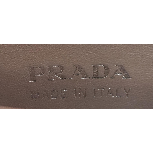 713 - A Prada Saffiano Leather Double Bag. White leather exterior with gold-tone hardware and top handles.... 