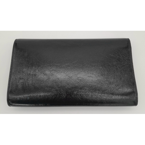 243 - A Saint Laurent Belle De Jour Clutch Bag. Black textured patent leather exterior featuring the class... 