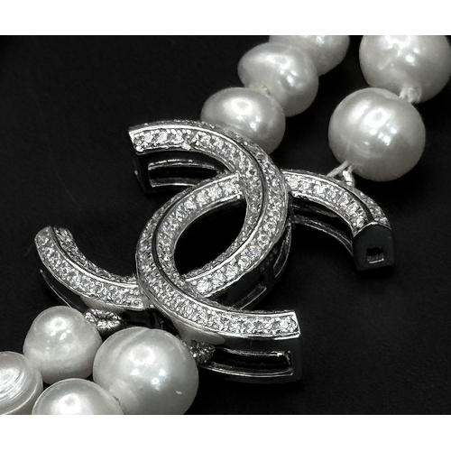 365 - A Cultured Two-Row Pearl Necklace with CC 925 Silver Clasp.
82cm