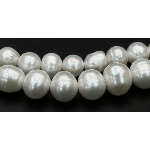 365 - A Cultured Two-Row Pearl Necklace with CC 925 Silver Clasp.
82cm