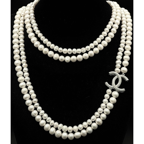 365 - A Cultured Two-Row Pearl Necklace with CC 925 Silver Clasp.
82cm