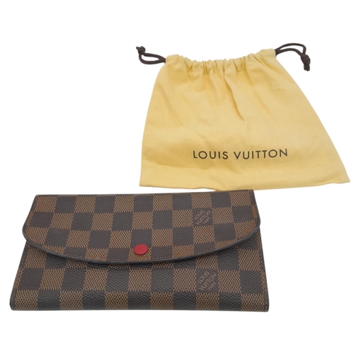 657 - A Louis Vuitton Damier Ebene Emilie Wallet. Crafted from signature Damier Ebene checkered canvas in ... 