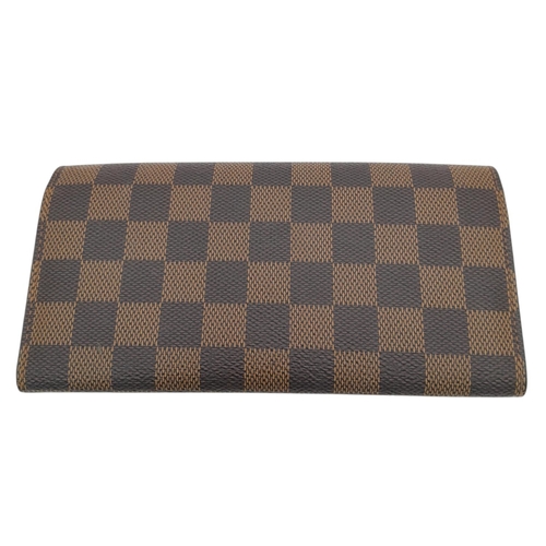 657 - A Louis Vuitton Damier Ebene Emilie Wallet. Crafted from signature Damier Ebene checkered canvas in ... 