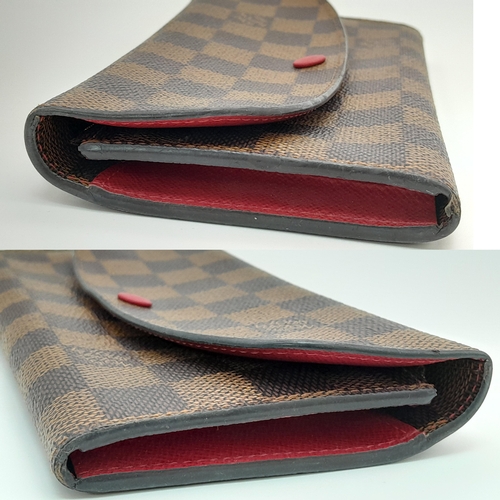 657 - A Louis Vuitton Damier Ebene Emilie Wallet. Crafted from signature Damier Ebene checkered canvas in ... 