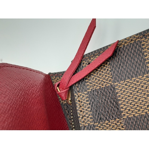 657 - A Louis Vuitton Damier Ebene Emilie Wallet. Crafted from signature Damier Ebene checkered canvas in ... 