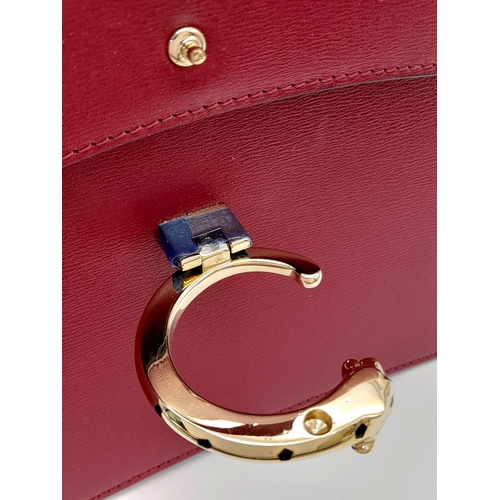 104 - A Panthère de Cartier Handbag. Crafted from poppy red calfskin leather with gold-toned hardware. Fea... 