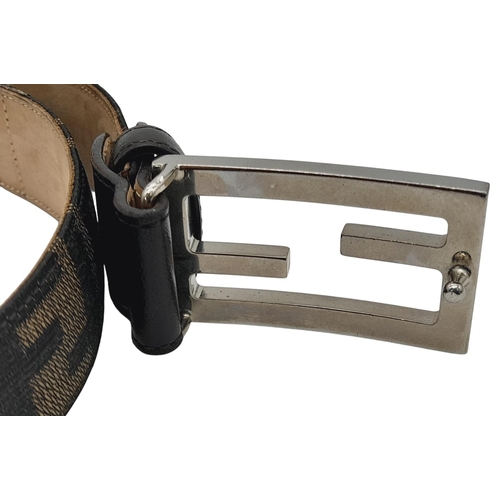 1050 - A Fendi Zucca FF Buckle Belt. Classic Zucca monogram canvas with black leather trim and a beige leat... 