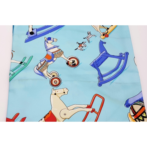 257 - An Hermes Silk Scarf. Equine decoration. 90 x 86cm. Original Hermes packaging. Some light staining s... 