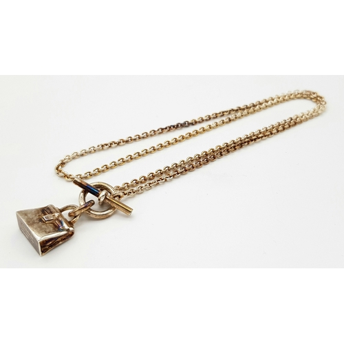 307 - An Hermes Gilded Silver (Kelly) Handbag Pendant on a Gilded Silver Chain. Original Hermes paperwork ... 