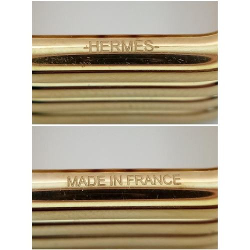 433 - An Hermes Gold Plated Ribbed Scarf Ring. 2.5cm x 2.5cm. Ref: 21013