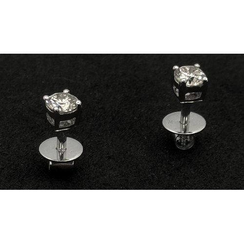 442 - A Pair of 18K White Gold and Diamond Stud Earrings. 0.20ctw. 1.2g. Comes with original diamond store... 