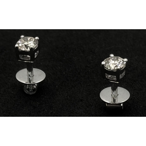 442 - A Pair of 18K White Gold and Diamond Stud Earrings. 0.20ctw. 1.2g. Comes with original diamond store... 