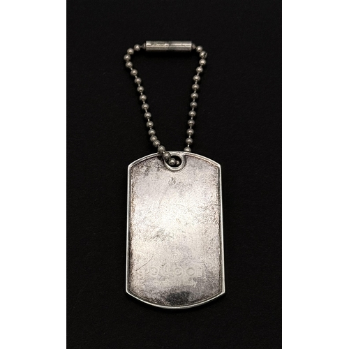 48 - A Brilliant Silver Mix: A Gucci Dog Tag Pendant - 4.5cm. A Tiffany and Co. Bangle - 6cm inner diamet... 