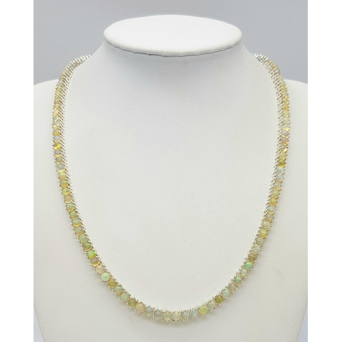 492 - An Opal Tennis Necklace. Set in 925 Silver. 45cm. Cd--1677