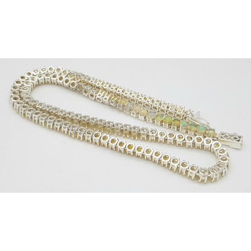 492 - An Opal Tennis Necklace. Set in 925 Silver. 45cm. Cd--1677