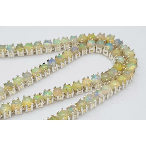 492 - An Opal Tennis Necklace. Set in 925 Silver. 45cm. Cd--1677