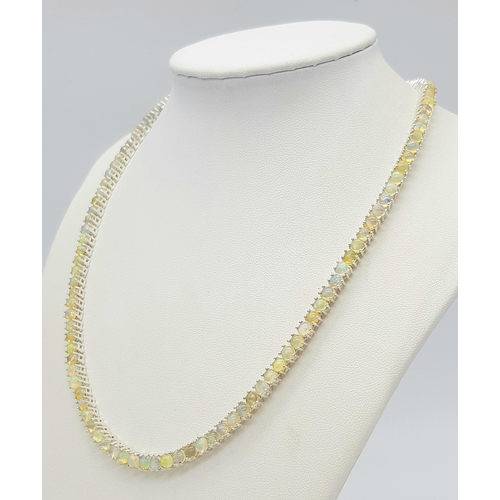 492 - An Opal Tennis Necklace. Set in 925 Silver. 45cm. Cd--1677